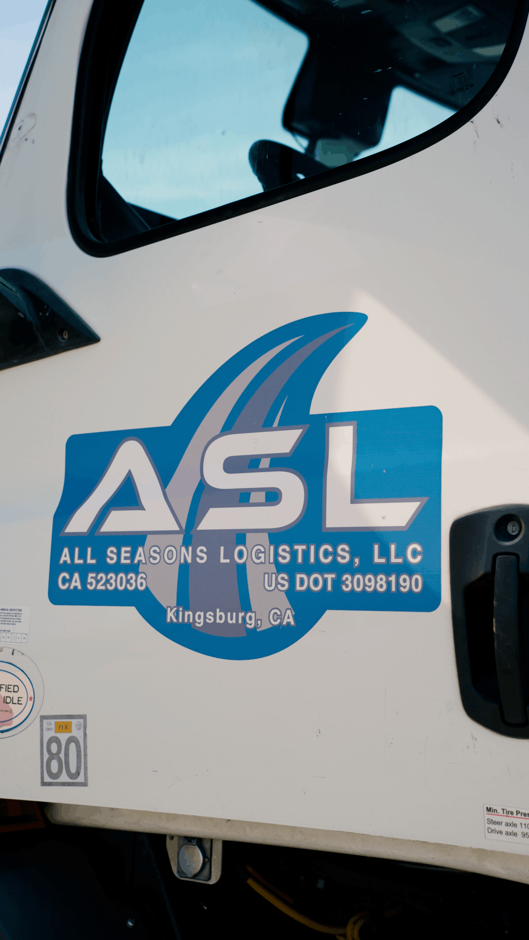 Close-up of the All Seasons Logistics logo on a truck door